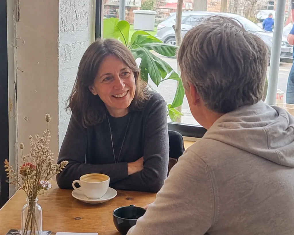 two-people-actually-meeting-coffee-shop-casual-setting-candid-rather-than-posed