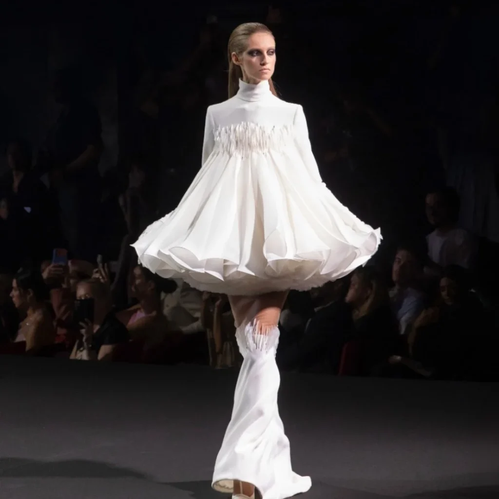Bell-shaped white couture mini dress over fishtail skirt