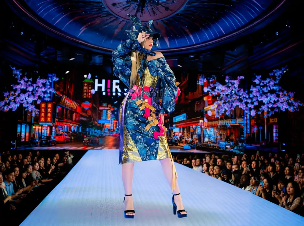 blue floral and gold brocade look with ribbons against a neon street backdrop
