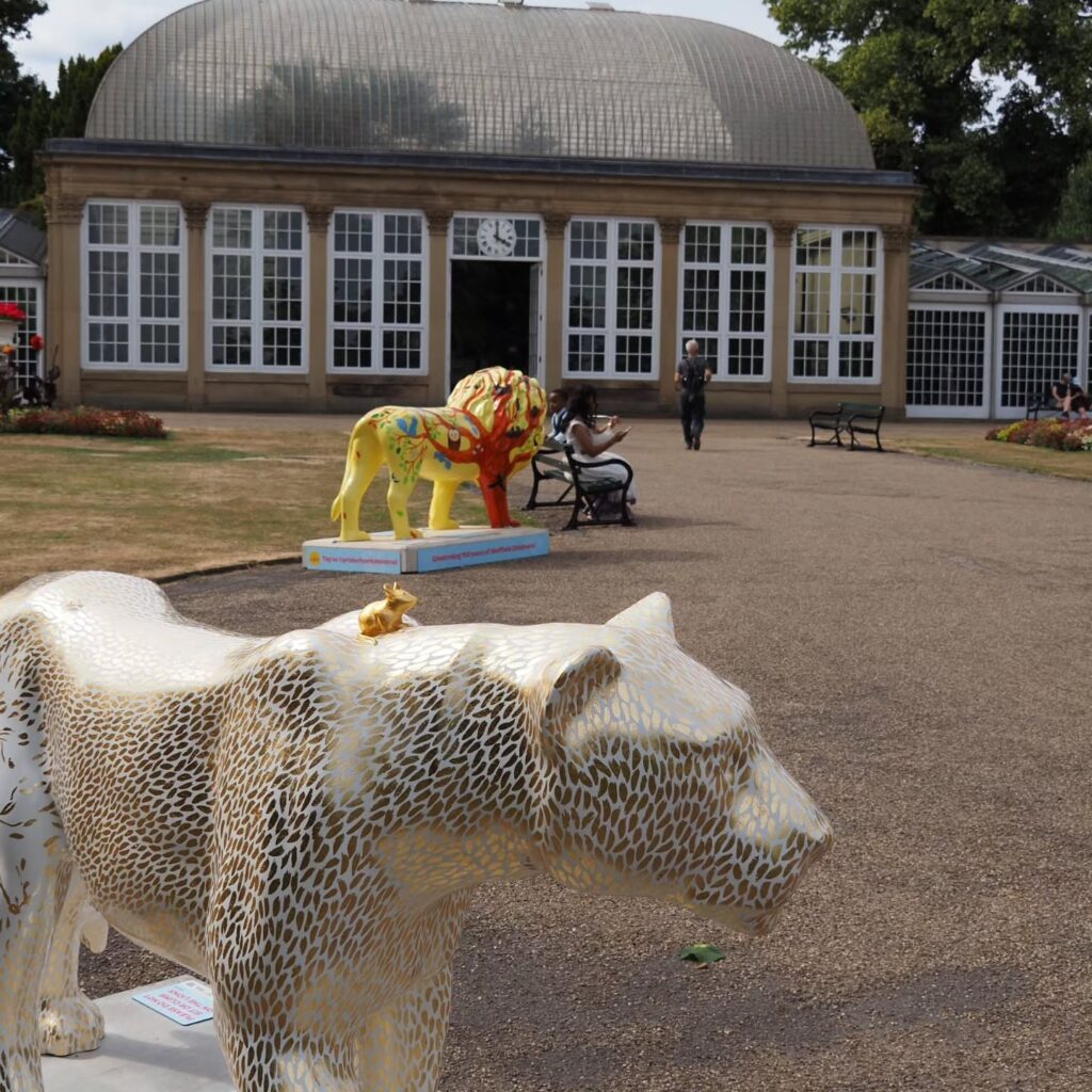 Pride of Yorkshire lion sculptures outside the glass pavilions at Sheffield Botanical Gardens