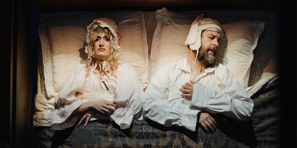 the marriage bed staged as comedy, bonneted wife wide awake beside her sleeping husband