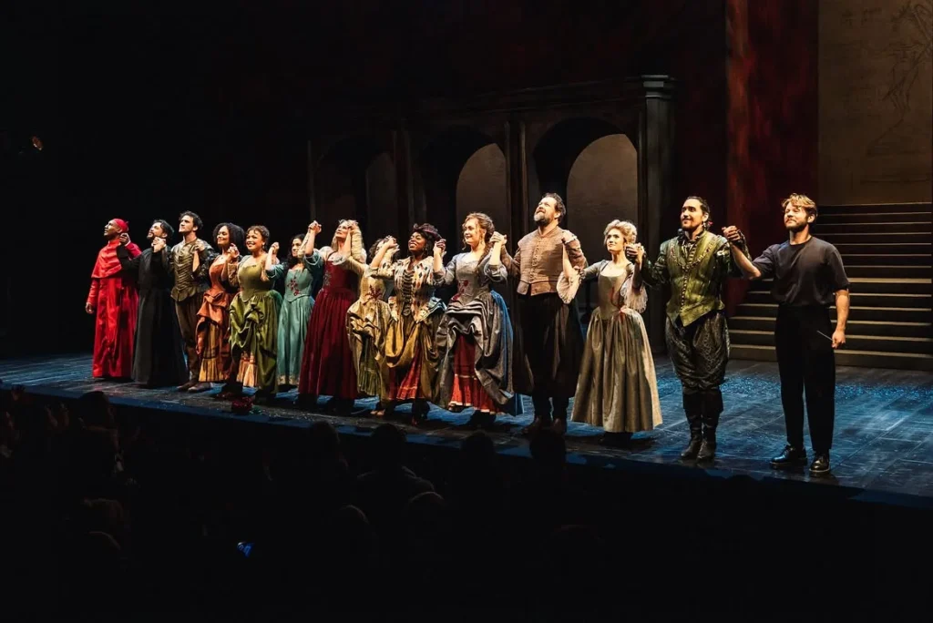 the full company's final curtain call, hands joined across the PAC NYC stage