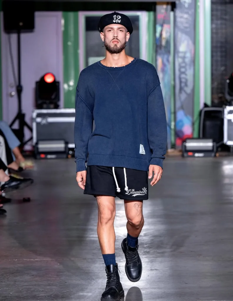 navy sweater and black 12 Decembers sweatshorts with white drawstrings